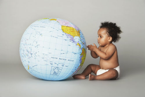 Photo of baby looking at globe