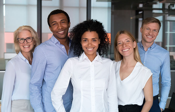 Diverse group of co-workers standing outside their office.