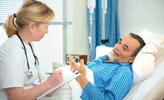 Nurse talking to patient and taking notes.