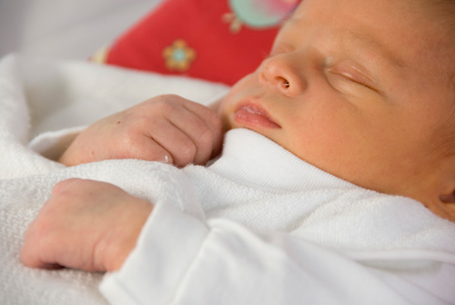 Newborn sleeping on it's back