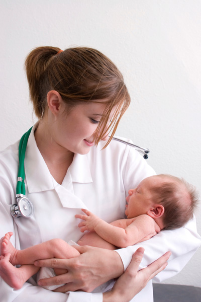 Female doctof holding newborn