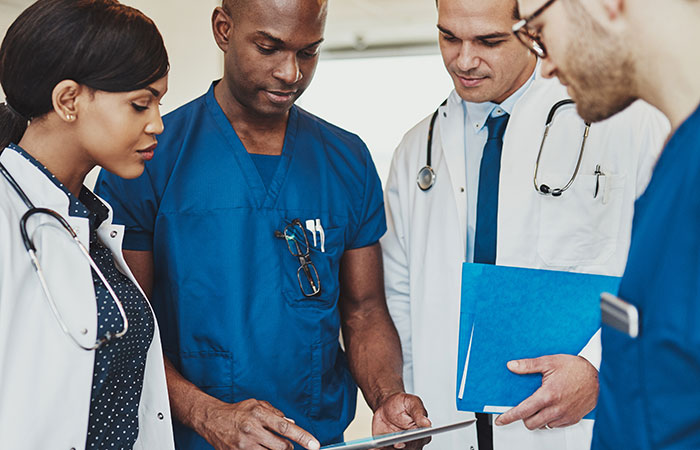 Health care workers working together and reading information