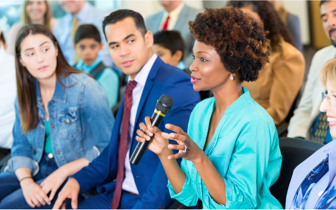 African American woman asks question during a meeting