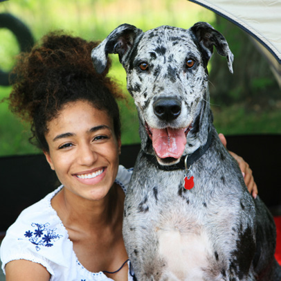 Woman sitting next to a dog