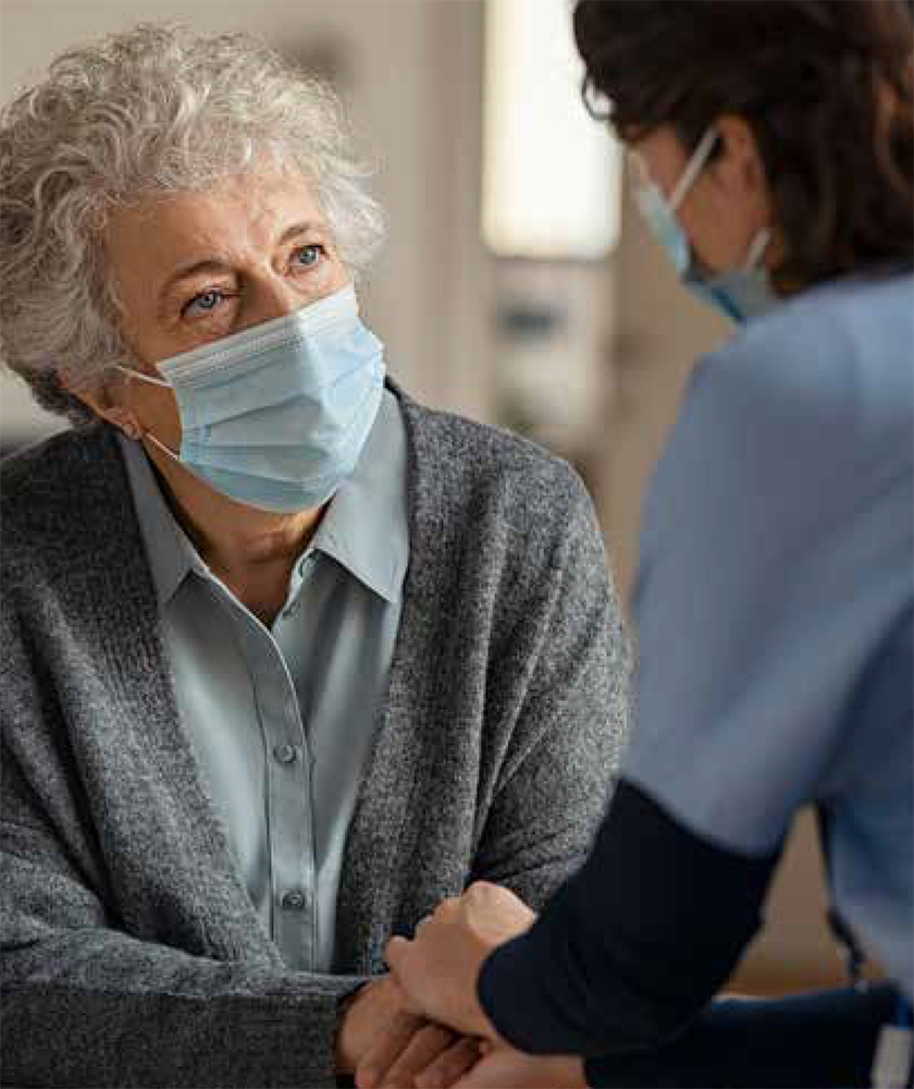 Elder woman talking with a nurse