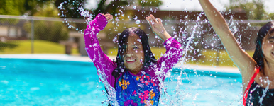 Two Young Hispanic Girls Playing in Swimming Pool in Summer Time Fun Photo Series