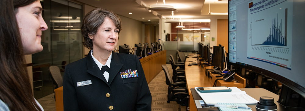 Jennifer McQuiston, DVM (CAPT, USPHS), analyzes the latest case counts with Hilary Kelly, MPH