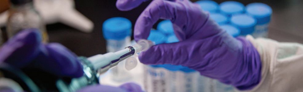 A scientist holding a tube