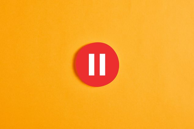 Red round circle with a pause button or icon