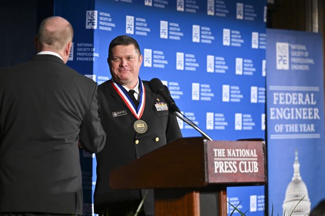 Bill Atkinson presents CAPT Martin with his award