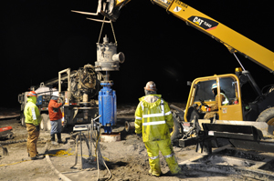 a work site where the large diameter drill bit is being lowered into place