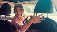 Woman looking back while reversing