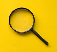 close up magnifier glass on yellow background