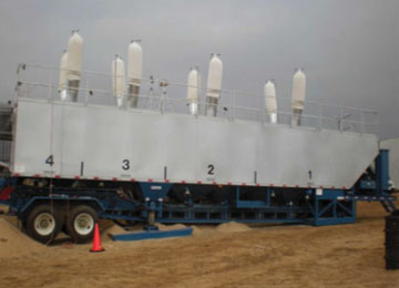 NIOSH mini-baghouse assemblies installed on eight thief hatches atop a sand mover during filling operations.