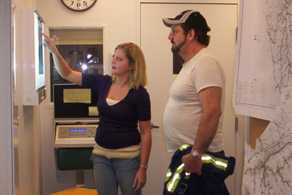 An x-ray technician explaining the basics of a chest x-ray to a coal miner in Harlan County, Kentucky, as part of the Enhanced Coal Workers' Health Surveillance Program.