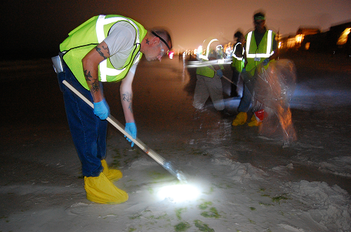 After Deepwater Horizon, response workers manually removed tar balls from the beach sand at Destin, Florida, during 12-hour night shifts. Photo by Aaron Sussell, CDCNIOSH.