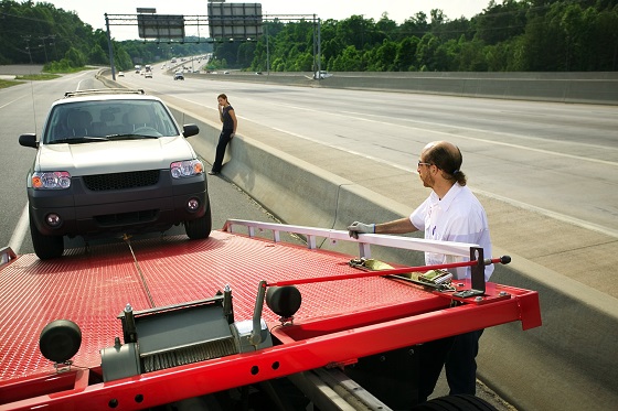 Tow truck driver loading car