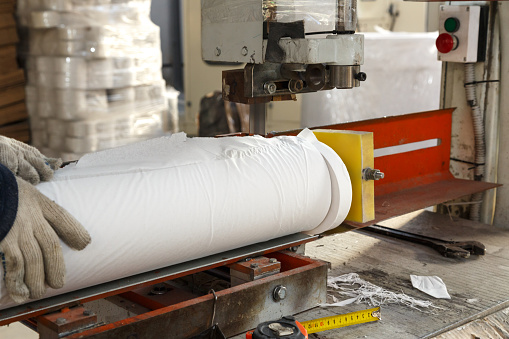 Worker in paper manufacturing plant.