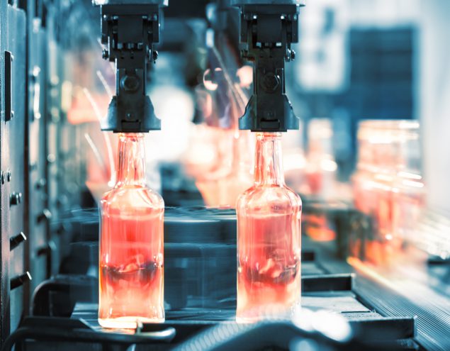 Hot glass bottles on a conveyor belt.