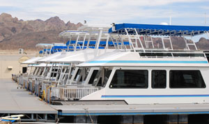 A photo of a fleet of houseboats tied to a dock.