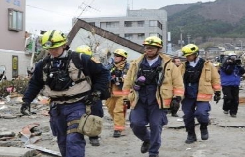 EMS workers walking thru disaster area