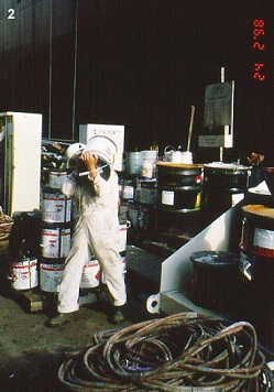 Worker carrying paint cans on shoulder