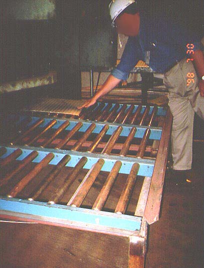 Worker using roller sections at the back of the shear