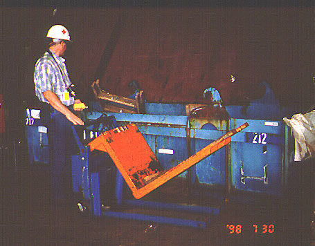 Worker using a tilting pallet jack