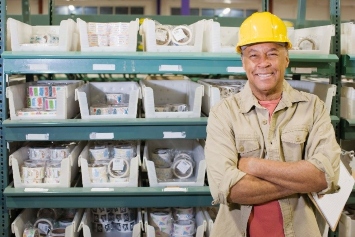 Worker standing infront of organzing bins