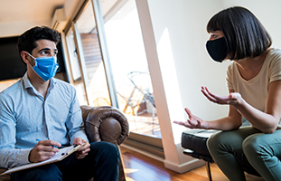 Psychologist talking with patient on therapy session