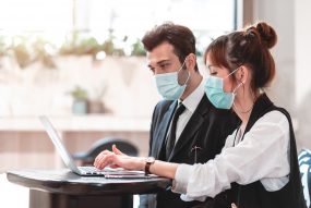 masked coworkers in office