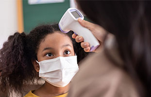 Person coughing and doctoring holding up xray