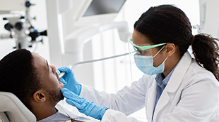 Female dentist with male patient