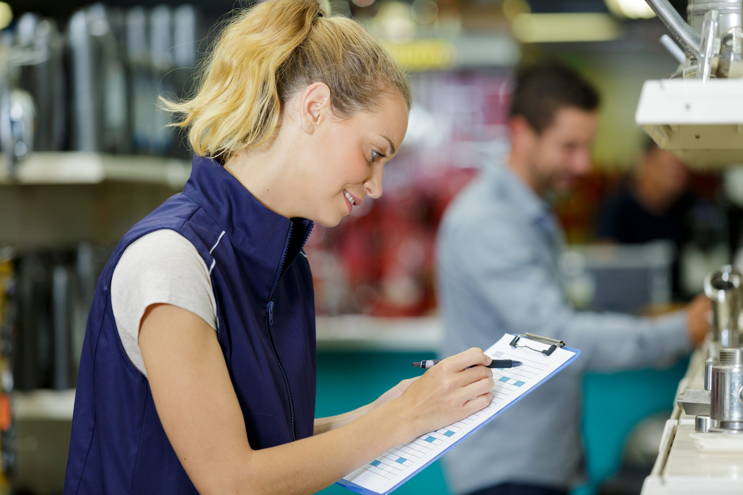 Woman taking notes while working in office