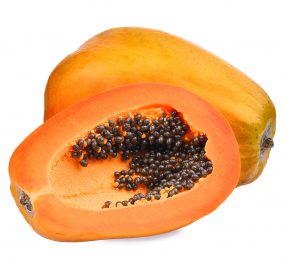 Photo of a papaya cut in half showing its seeds.