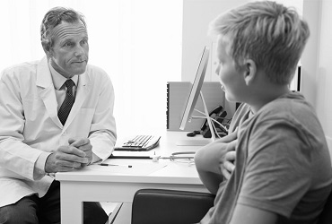 Doctor conversing with young patient