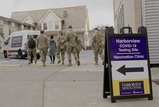 Healthcare workers walking towards a van