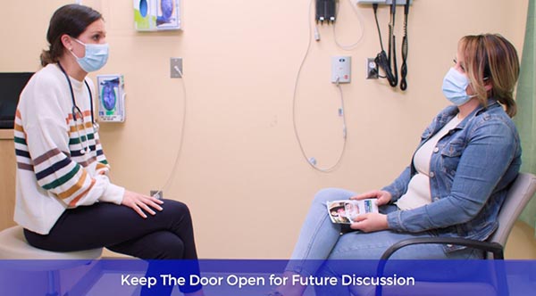 healthcare worker talking with female patient