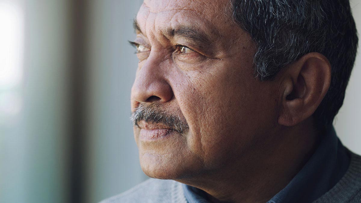 lone black older man looking away from camera