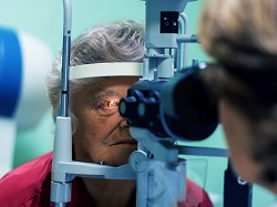 Older woman receiving an eye exam